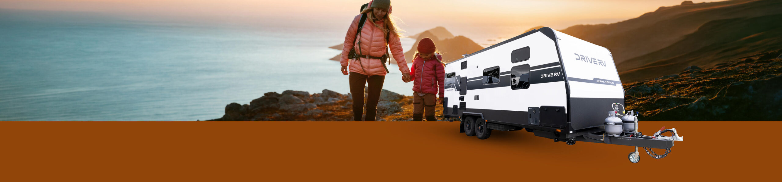 Drive RV Alpha Edition caravan in a coastal mountain landscape